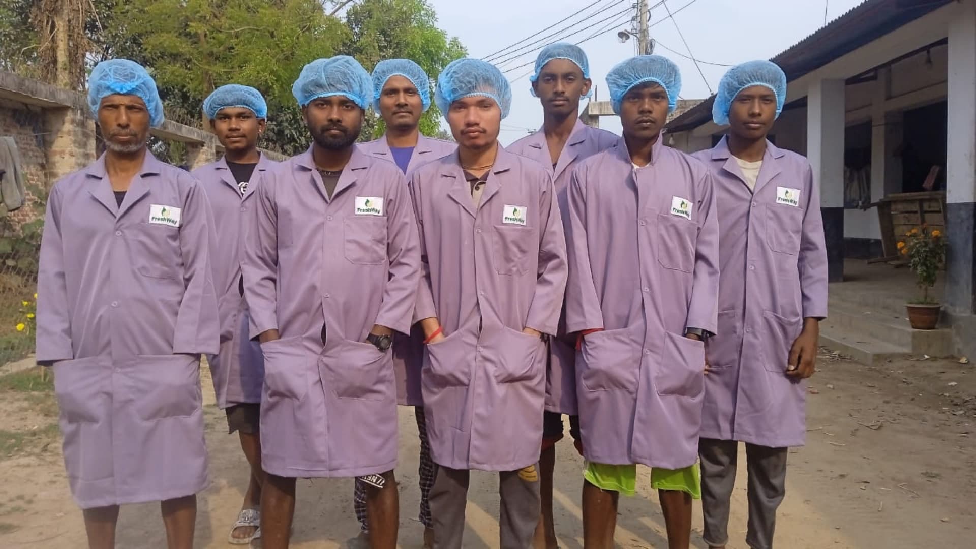 A team of FarmWise contract farmers in FreshWay coats